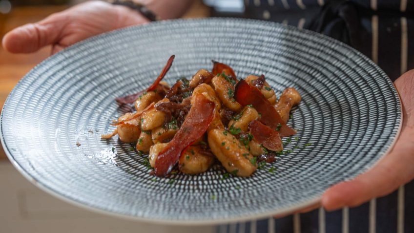 Hand rolled potato gnocchi with prosciutto and red onion jam